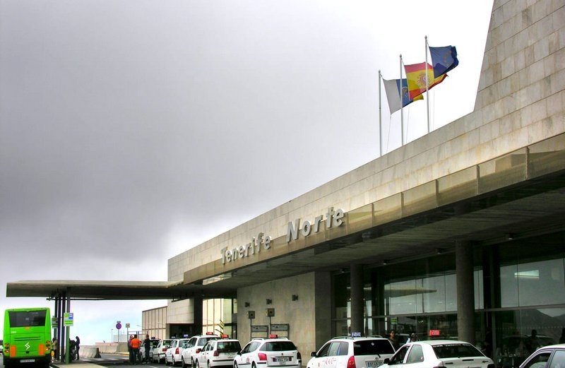Tenerife North Airport - green bus and taxi near terminal